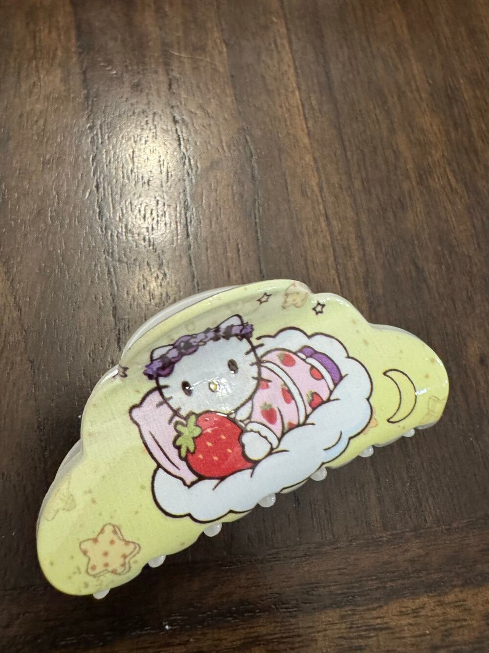 Hello Kitty Strawberry Hair Claw sleeping in a cloud with a strawberry